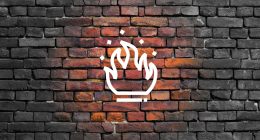 A flame icon glows warmly over a wall of grey brick.