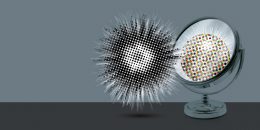 A round mirror sits on top of a table, with a stylized, star-like glow effect shining beside.